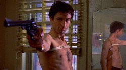 "You talkin' to me?"  Alone in his apartment, Travis postures and practices his moves in front of the mirror