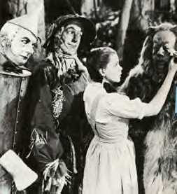 from left to right, Jack Haley, Ray Bolger, Judy Garland, and Bert Lahr